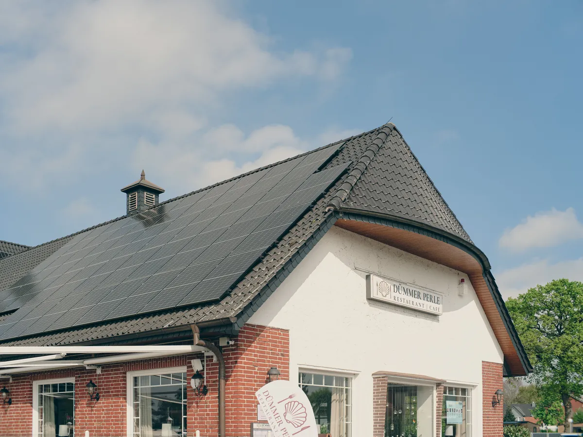 Solar panels fitted on a dark tiled house roof